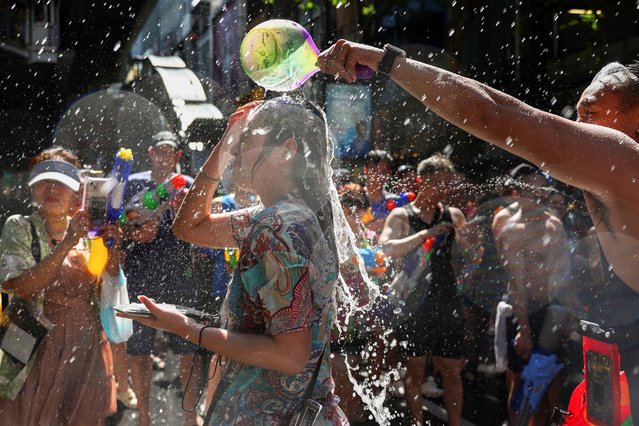 Revellers play with water as they celebrate the Songkran holiday, which marks the Thai New Year, in Bangkok, Thailand, on April 13, 2025. (Photo by Chalinee Thirasupa/Reuters)