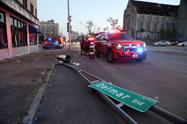 A Delmar Boulevard street sign lies on the ground as fire crew respond to tornado damage in St. Louis, Missouri, on May 16, 2025. (Photo by Lawrence Bryant/Reuters)