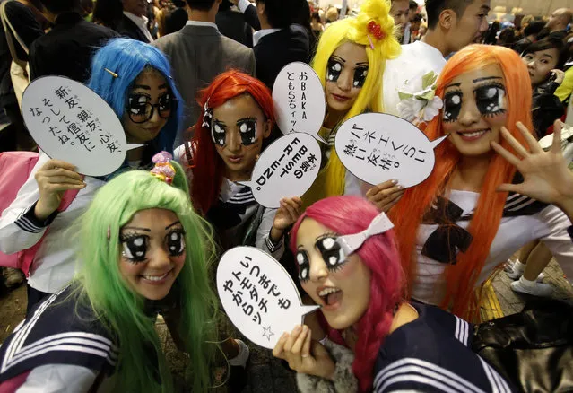 Participants wearing make-up and costumes pose during Halloween night in Tokyo's Shibuya district, October 31, 2014. (Photo by Yuya Shino/Reuters)