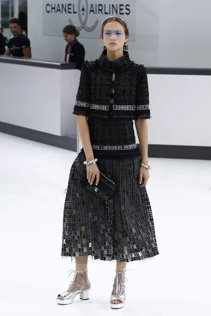 A model presents a creation by German designer Karl Lagerfeld as part of his Spring/Summer 2016 women's ready-to-wear collection show for fashion house Chanel at the Grand Palais which is transformed into a Chanel airport during Fashion Week in Paris, France, October 6, 2015. (Photo by Benoit Tessier/Reuters)