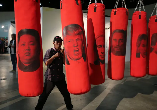 A visitor hits a punching bag bearing an image of US president Donald Trump among other world leaders as part of an installation artwork entitled “Left or Right” during the opening of the LA Art Show in Los Angeles, California, USA, 10 January 2018. The interactive piece allows visitors to release their angers and anxieties on the bags. (Photo by Eugene Garcia/EPA/EFE)