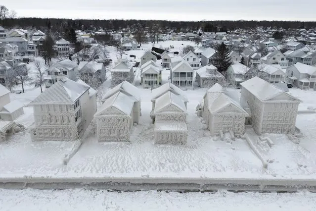 In this image taken by drone, houses along the shores of Lake Erie, near Fort Erie, Ontario, remain covered in ice Tuesday, December 27, 2022, following a winter storm that swept through much of Ontario. (Photo by Nick Iwanyshyn/The Canadian Press via AP Photo)