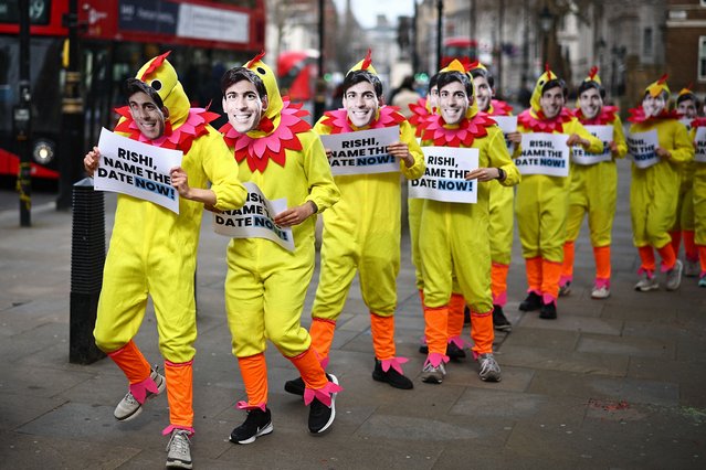 Activists from Britain's main opposition Labour Party pose for a photograph dressed in chicken suits wearing masks of Britain's Prime Minister Rishi Sunak, to encourage him to call a General Election, in central London, on March 15, 2024. Britain's Prime Minister Rishi Sunak on Thursday ruled out calling the election on May 2 to coincide with local polls. He could wait until January 2025 to go to the country but has said his “working assumption” is the vote will be in the second half of the year. (Photo by Henry Nicholls/AFP Photo)