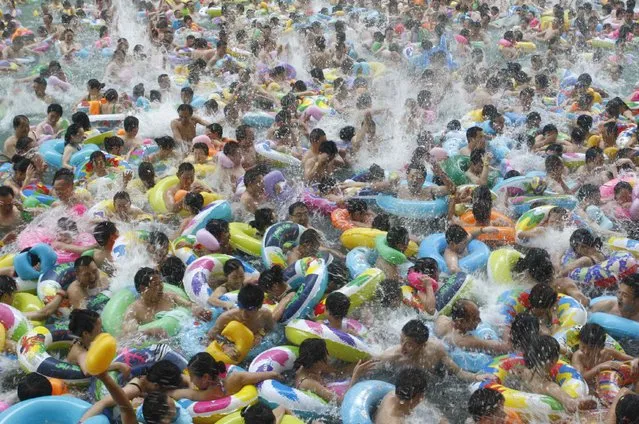 Residents crowd in a swimming pool to escape the summer heat during a hot weather spell in Daying county of Suining, Sichuan province July 4, 2010. (Photo by Reuters/Stringer)