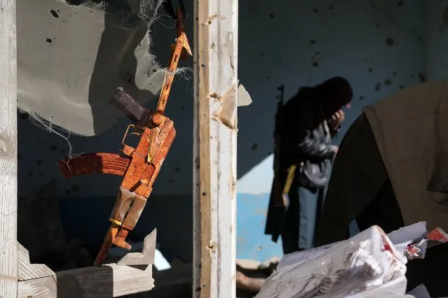 A gun hangs in a destroyed house belonging to Islamic State group fighters that was destroyed in the ongoing conflict with the Taliban in Kabul, Afghanistan, Thursday, January 5, 2023. (Photo by Ebrahim Noroozi/AP Photo)