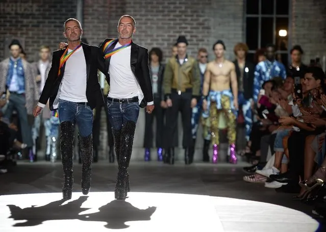 Fashion designers Dan Caten and Dean Caten greet the audience at the end of the show for fashion house Dsquared2 during the Men's Spring – Summer 2017 fashion shows, on June 17, 2016 in Milan. (Photo by Filippo Monteforte/AFP Photo)
