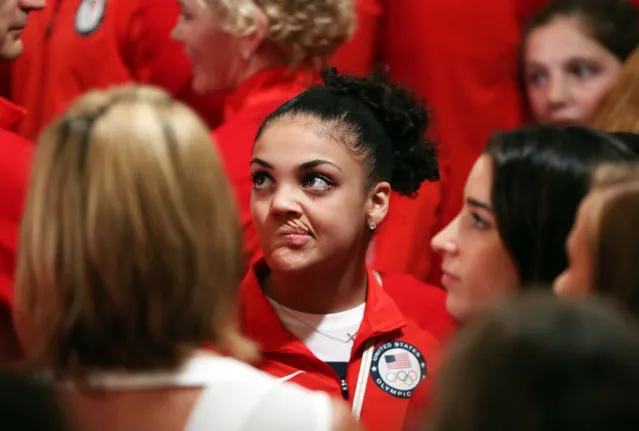 Olympic gold medal gymnasts Laurie Hernandez, center, makes a face, while talking to fellow Olympians in the East Room of the White House in Washington, Thursday, September 29, 2016, before the start of a ceremony where President Barack Obama honored members of the 2016 United States Summer Olympic and Paralympic Teams. At left is fellow gymnast Aly Raisman. (Photo by Manuel Balce Ceneta/AP Photo)