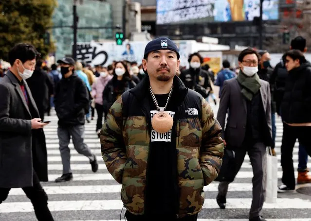 Masataka Shishido, also known as DJ Doooo, poses with his hyper realistic flesh-like object 'eye dice' in Tokyo, Japan on February 2, 2023. (Photo by Kim Kyung-Hoon/Reuters)