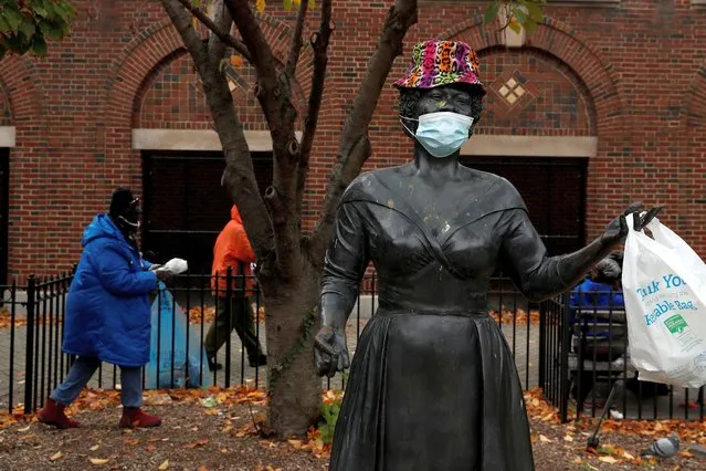 A bronze statue of late singer Ella Fitzgerald is seen wearing a hat and protective face mask, as the global outbreak of the coronavirus disease (COVID-19) continues, outside the Metro-North Railroad Station Plaza in Yonkers, New York, U.S., November 17, 2020. (Photo by Shannon Stapleton/Reuters)