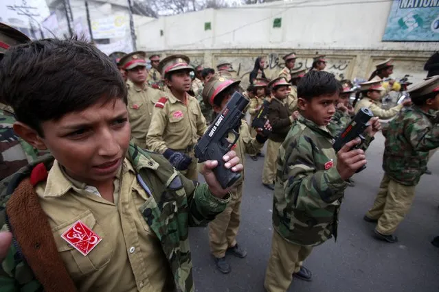 Boys hold toy guns as they chant slogans to condemn the Taliban attack on the Army Public School in Peshawar, during a rally in Lahore December 19, 2014. (Photo by Mohsin Raza/Reuters)