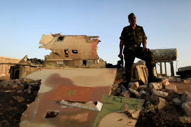 Sidi Brahim Mohamed Embarek talks to Reuters journalists as he stands beside the wreckage of a Moroccan air force F-5, which was shot down by the Polisario in a 1991 battle in the Western Sahara war, in Tifariti, September 9, 2016. (Photo by Zohra Bensemra/Reuters)