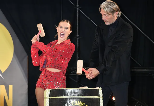 British actress Millie Bobby Brown and Danish actor Mads Mikkelsen break the sake barrel during the opening ceremony for Osaka Comic Con 2023 at the Intex Osaka on May 5, 2023 in Osaka, Japan. (Photo by Jun Sato/WireImage)
