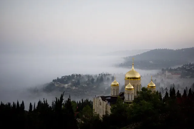 Fog forms beneath the Gorny Convent of the Russian Orthodox Church in Ein Kerem, an ancient village near Jerusalem Sunday. November 8, 2015. (Photo by Dusan Vranic/AP Photo)