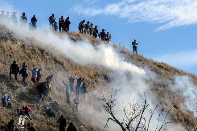 Police use tear gas on protesters occupying Turtle Island during a protest of the Dakota Access pipeline near the Standing Rock Indian Reservation near Cannon Ball, North Dakota November 6, 2016. (Photo by Stephanie Keith/Reuters)