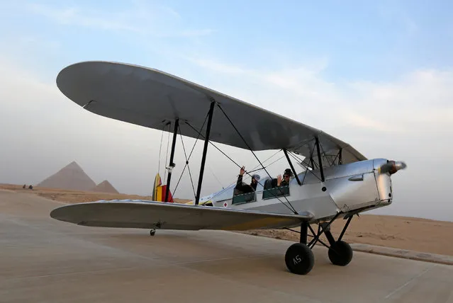 A biplane flown by Cedric Collette and Alexandra Maingard begins its flight in the desert just beyond Egypt's iconic pyramids of Giza, on the second leg of their month-long journey through Africa in Cairo, Egypt, November 13, 2016. (Photo by Mohamed Abd El Ghany/Reuters)