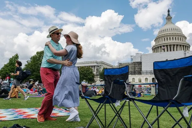 Sean Salai and Sarah Cooley dance on the West Lawn of the US Capitol in anticipation of A Capital Fourth in Washington, DC on Independence Day, July 04, 2023. (Photo by Craig Hudson for The Washington Post)