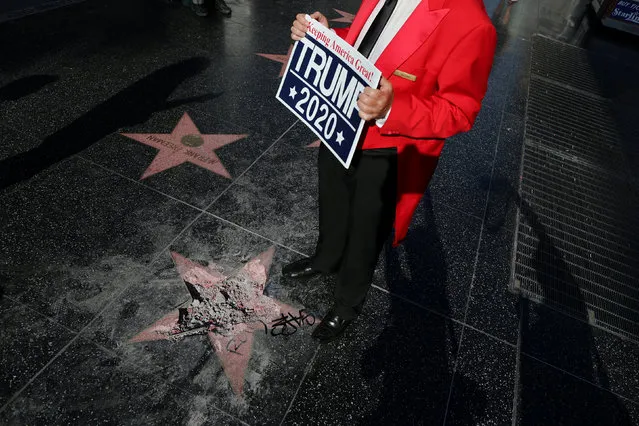 Greg Donovan, 58, stands on President Donald Trump's vandalized star on the Hollywood Walk of Fame in Hollywood, Los Angeles, California, U.S. July 25, 2018. (Photo by Lucy Nicholson/Reuters)