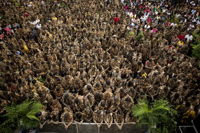 Devotees wearing costumes made of banana leaves attend a mass as part of a religious festival in honor of St. John the Baptist, also known locally as the “mud people” festival, in Aliaga town, Nueva Ecija province, north of Manila, on June 24, 2018. Farmers coated in mud paraded in Philippine villages on June 24 to mark one of the Catholic nation's most colourful religious festivals. (Photo by Noel Celis/AFP Photo)