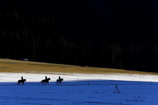 People on horses make their way over snow covered meadows near Haller, Austria, Wednesday, December 30, 2015. The weather forecast predicts cold weather with rain for the upcoming days. (Photo by Matthias Schrader/AP Photo)