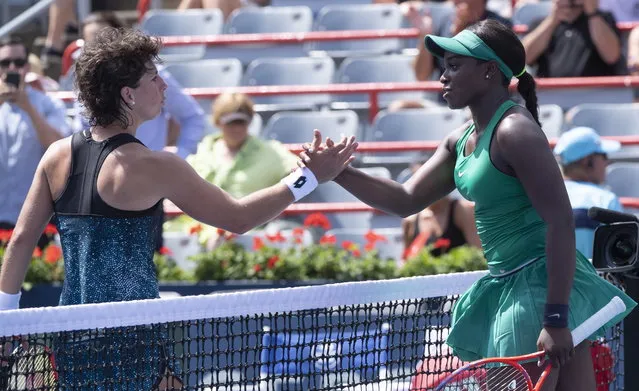 Sloane Stephens, of the Unites States, right, is congratulated by Carla Suarez Navarro, of Spain, following her victory at the Rogers Cup women's tennis tournament, Thursday August 9, 2018 in Montreal. (Photo by Paul Chiasson/The Canadian Press via AP Photo)
