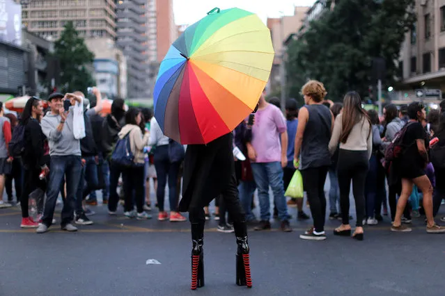 A protester wearing high heels during a demonstration to support International Day for the Elimination of Violence Against Women in Santiago, Chile, November 25, 2016. (Photo by Pablo Sanhueza/Reuters)