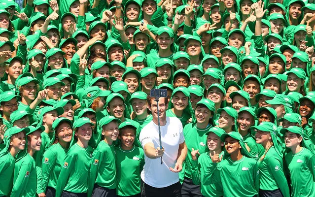 Andy Murray of Great Britain takes a selfie with ballkids from Australia and overseas during the annual ballkid team photo ahead of the 2016 Australian Open at Melbourne Park on January 12, 2016 in Melbourne, Australia. The Australian Open 2016 ballkid squad is comprised of 329 ballkids from Victoria, 25 ballkids from interstate and 30 ballkids from overseas including 20 from Korea, six from China and two from Singapore.  (Photo by Scott Barbour/Getty Images)
