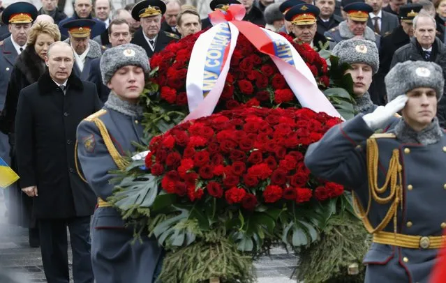 Russian President Vladimir Putin (L) attends a wreath laying ceremony to mark the Defender of the Fatherland Day at the Tomb of the Unknown Soldier by the Kremlin walls in central Moscow February 23, 2015. (Photo by Sergei Karpukhin/Reuters)