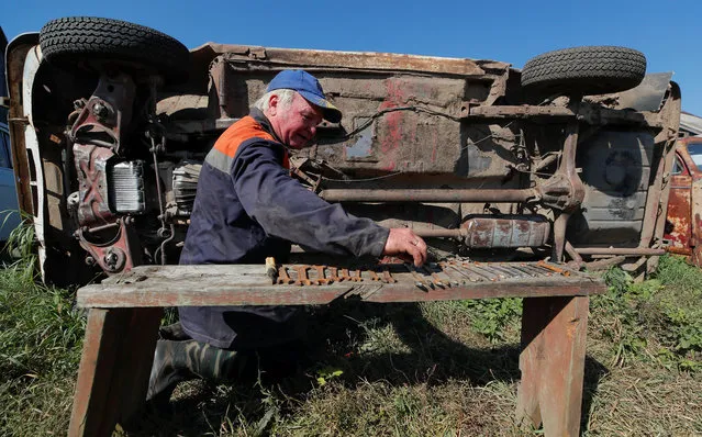 Retired mechanic and retro car collector, Krasinets repairs a car at an open-air museum of Soviet-era vehicles in the village of Chernousovo, Tula region, Russia on September 27, 2018. (Photo by Maxim Shemetov/Reuters)