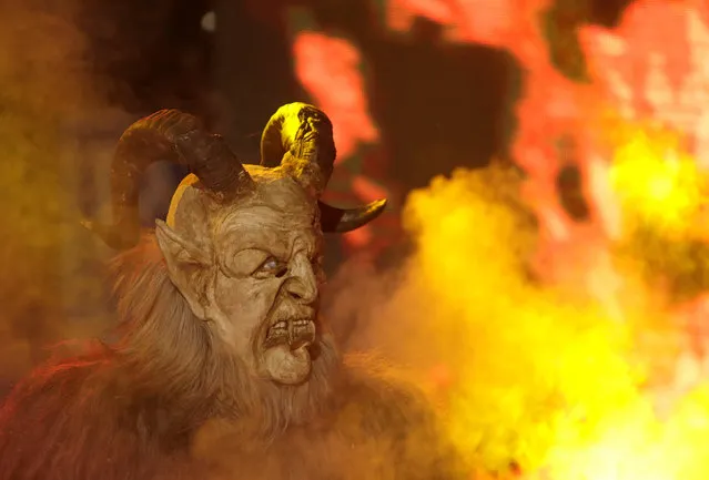 A man dressed as a devil performs during a Krampus show, the traditional parade where people in costumes and masks perform an old ritual to disperse the ghosts of winter, in the southern Bohemian town of Kaplice, December 10, 2016. (Photo by David W. Cerny/Reuters)