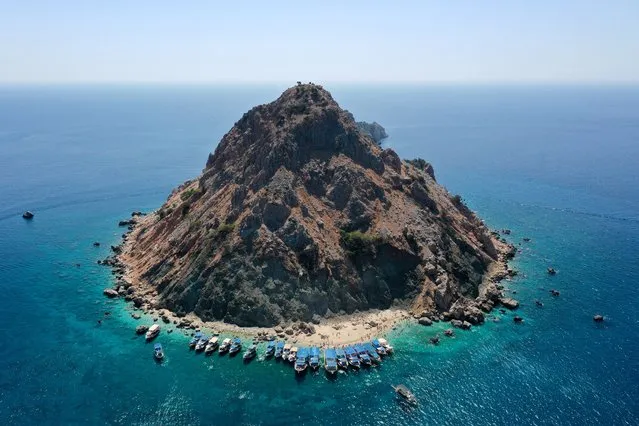 An aerial view of 'Suluada' located off the coast of Adrasan, in the Kumluca district of Antalya, Turkiye on August 24, 2023. Local and foreign tourists, who reach the uninhabited island by boat, enjoy the clear turquoise water and white sands. (Photo by Bekir Bektas/Anadolu Agency via Getty Images)