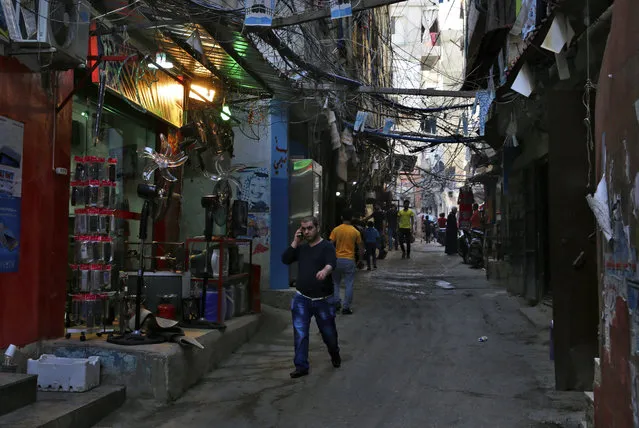 In this Thursday, May 4, 2017 photo, people walk inside the Bourj al-Barajneh Palestinian refugee camp in Beirut, Lebanon. (Photo by Bilal Hussein/AP Photo)