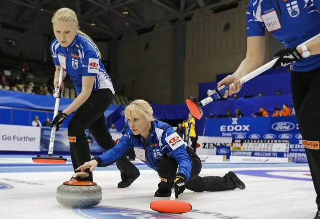 Finland's skip Saana Puustinen delivers a stone as her teammate Oona Kauste sweeps during her curling round robin game against Denmark at the World Women's Curling Championships in Sapporo March 15, 2015. (Photo by Thomas Peter/Reuters)