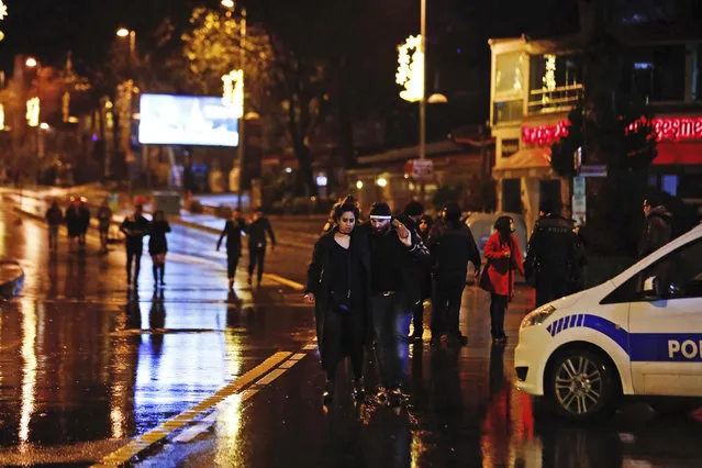 Young people leave from the scene of an attack in Istanbul, early Sunday, January 1, 2017. (Photo by Halit Onur Sandal/AP Photo)
