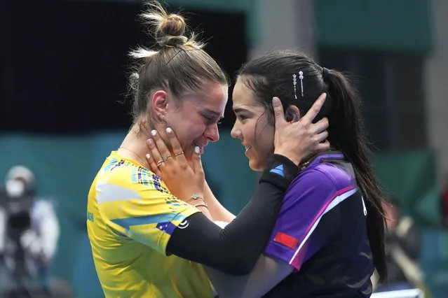 Puerto Rico's Adriana Diaz, right, embraces Brazil's Bruna Takahashi, after winning the women's singles table tennis final at the Pan American Games in Santiago, Chile, Wednesday, November 1, 2023. Takahashi won the silver medal. (Photo by Dolores Ochoa/AP Photo)