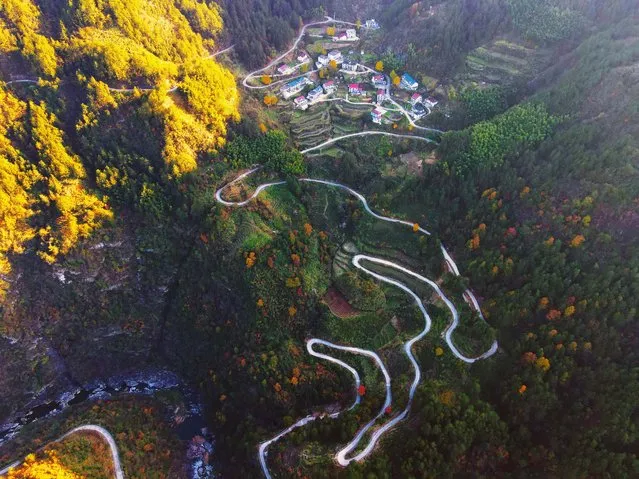 A winding, hardened road passes through villages in the hinterland of the Dabie Mountains in Anqing city, Anhui province, China on November 19, 2023. (Photo by Costfoto/NurPhoto/Rex Features/Shutterstock)