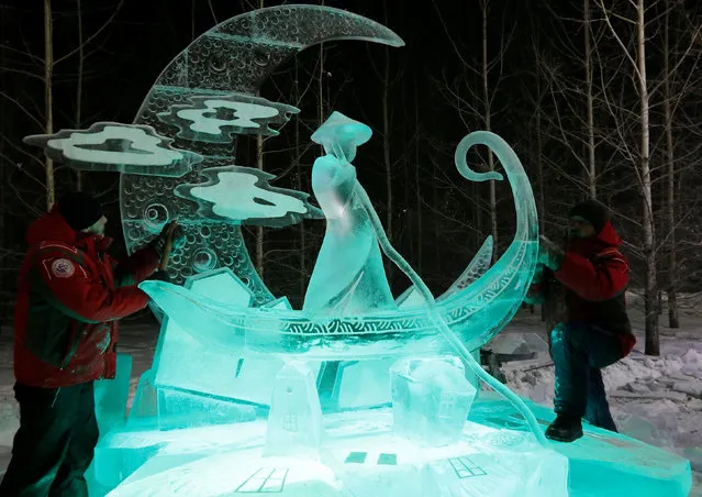 Members of the “Magical Ice” team of Russia work on the ice sculpture called “Dream Catcher” during the international festival of snow and ice sculptures  “The Magical Ice of Siberia” in Krasnoyarsk, Russia January 7, 2017. (Photo by Ilya Naymushin/Reuters)