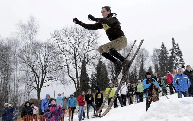 A participant jumps on vintage skis during a traditional historical ski race in the northern Bohemian town of Smrzovka, Czech Republic, February 20, 2016. (Photo by David W. Cerny/Reuters)