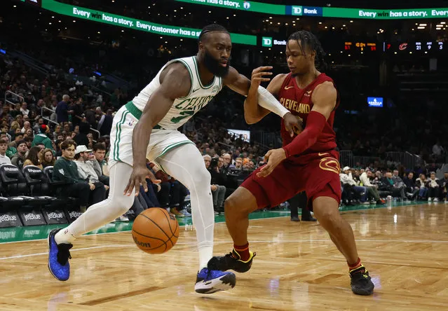 Jaylen Brown #7 of the Boston Celtics tries to ward off Isaac Okoro #35 of the Cleveland Cavaliers during the second half at TD Garden on December 14, 2023 in Boston, Massachusetts. (Photo By Winslow Townson/Getty Images)
