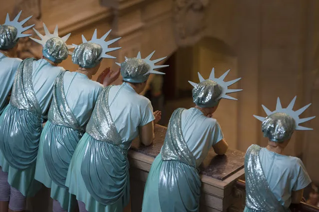 Dancers of a carnival club, dressed as Statue of Liberty, watch performances of other clubs  in the Saxony governor's office in Dresden, eastern Germany on January 25, 2017. Photo by Arno Burgi/DPA via AP Photo)