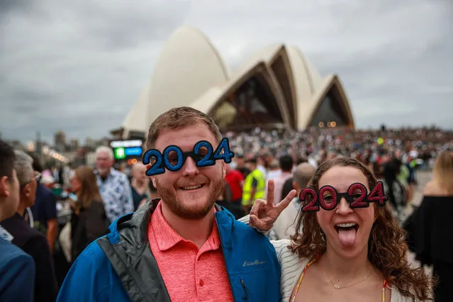 Crowds gather at Sydney Opera House ahead of New Year's Eve celebrations on December 31, 2023 in Sydney, Australia. Revellers turned out in large numbers to celebrate the new year in Australia. (Photo by Roni Bintang/Getty Images)