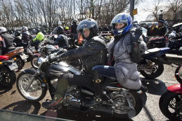 Members of the Night Wolves biker group gather to see off Russian bikers leaving for Germany to mark the 70th anniversary of Soviet victory over Nazi Germany, in Moscow, Saturday, April 25, 2015. Riders from the Night Wolves, a Russian nationalist motorcycle group, have begun their run commemorating the Red Army's offensive against Nazi Germany, despite Poland's announcement that it would refuse to let them in the country. (Photo by Alexander Zemlianichenko/AP Photo)