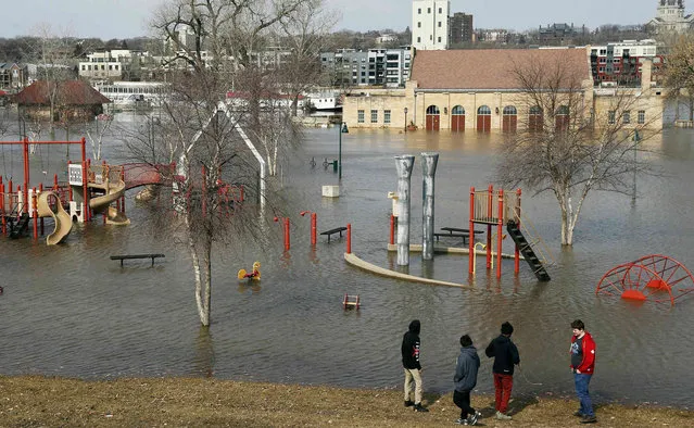 Mississippi River floodwaters inundate the pavilion and a play area at Harriet Island Wednesday, March 27, 2019 in St. Paul, Minn. (Photo by Jim Mone/AP Photo)