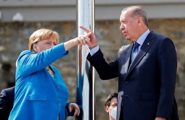 Turkish President Tayyip Erdogan and German Chancellor Angela Merkel chat on the balcony of Huber Mansion before their meeting in Istanbul, Turkey, October 16, 2021. (Photo by Murad Sezer/Reuters)