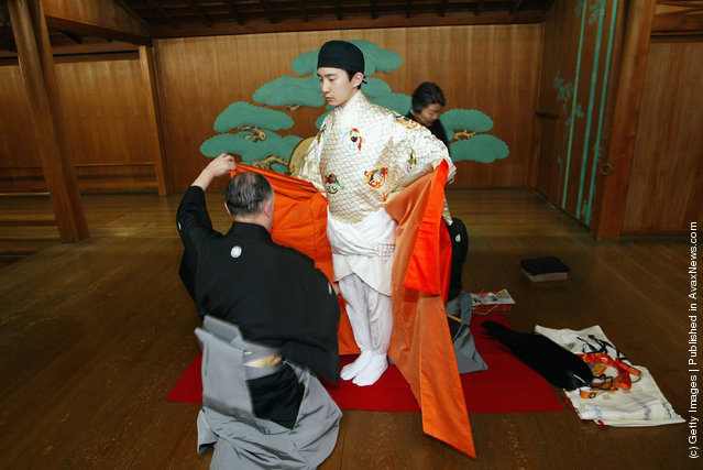 A traditional Japanese Noh actor gets his masks and costumes put on prior to demostrating a performance of the ancient theatrical art