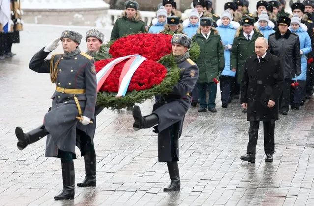 In this pool photograph distributed by Russian state agency Sputnik, Russia's President Vladimir Putin attends a wreath-laying ceremony at the Tomb of the Unknown Soldier by the Kremlin Wall to mark the Defender of the Fatherland Day in Moscow on February 23, 2024. (Photo by Sergei Savostyanov/Pool via AFP Photo)