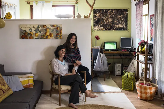 Vered, 43, poses for a photograph with her daughter Alma, 13, in their home in Kibbutz Hukuk near the Sea of Galilee in northern Israel March 3, 2014. Vered got a degree in design at the age of 27 and currently runs educational art projects in local communities. Vered hopes that her daughter Alma will find a profession that brings her happiness and satisfaction. Alma will graduate high-school in five years, at the age of 18. She says she would like to be a part of the film industry, as a director, as camerawoman, an editor or an actress. (Photo by Nir Elias/Reuters)