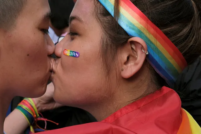 A couple kisses as they celebrate after Taiwan became the first place in Asia to legalize same-s*x marriage, outside the Legislative Yuan in Taipei, Taiwan on May 17, 2019. (Photo by Tyrone Siu/Reuters)