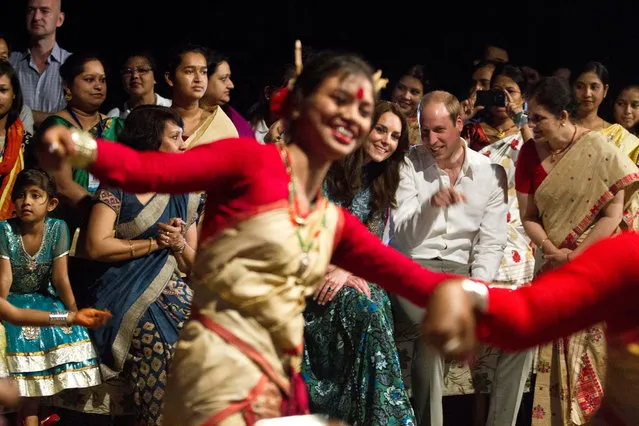 Britain's Prince William, sitting center right, along with Kate, the Duchess of Cambridge watches Assamese traditional dancers perform in Diphlu River Lodge in the Kaziranga National Park, east of Gauhati, northeastern Assam state, India, Tuesday, April 12, 2016. The British royal couple is visiting the wildlife park specifically to focus global attention on conservation. The 480-square-kilometer (185-square-mile) grassland park is home to the world's largest population of rare, one-horned rhinos as well as other endangered species, including swamp deer and the Hoolock gibbon. (Photo by Anupam Nath/AP Photo)