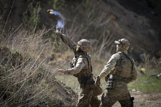 Members of the Siberian Battalion, which was formed mostly of volunteer Russian citizens, of the Ukrainian Armed Forces' International Legion, practice during military exercises, amid Russia's attack on Ukraine, at an undisclosed location in Kyiv region, Ukraine, Wednesday, April 10, 2024. (Photo by Efrem Lukatsky/AP Photo)