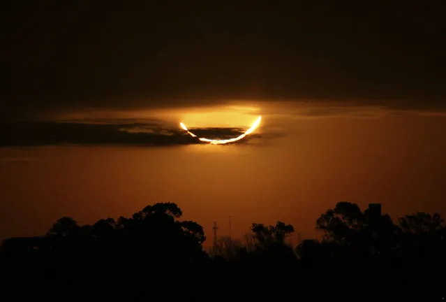 The moon blocks the sun during a total solar eclipse, seen from Buenos Aires, Argentina, Tuesday, July 2, 2019. A solar eclipse occurs when the moon passes between the Earth and the sun and scores a bull's-eye by completely blocking out the sunlight. (Photo by Marcos Brindicci/AP Photo)